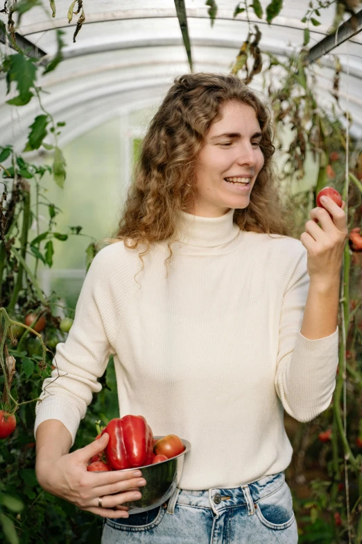 a woman holding a bowl of tomatoes in a greenhouse, by Julia Pishtar, wearing turtleneck, curls, white, official product photo