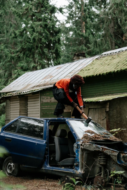 a man that is standing on top of a car, pexels contest winner, auto-destructive art, wielding an axe, cabin in the woods, pulling weeds out frantically, seattle