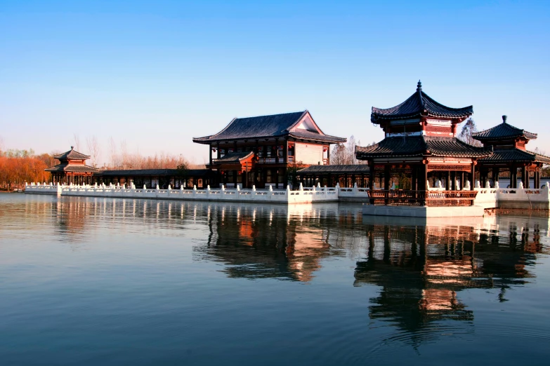 a large building sitting on top of a lake, inspired by Yang Buzhi, pexels contest winner, hurufiyya, on a bright day, carrington, tang dynasty, exterior