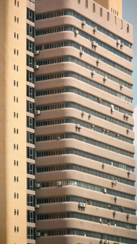 a tall building with a clock on top of it, inspired by Ned M. Seidler, brutalism, cairo, getty images, apartment, brown