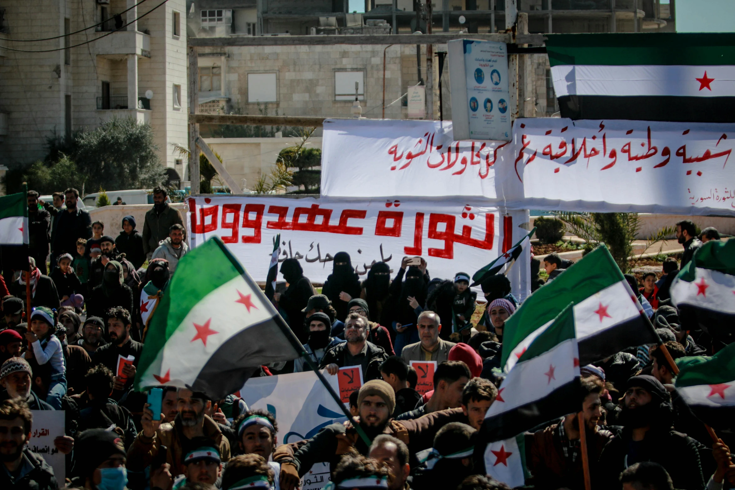 a large group of people holding flags and banners, hurufiyya, white helmet, february), square, thumbnail