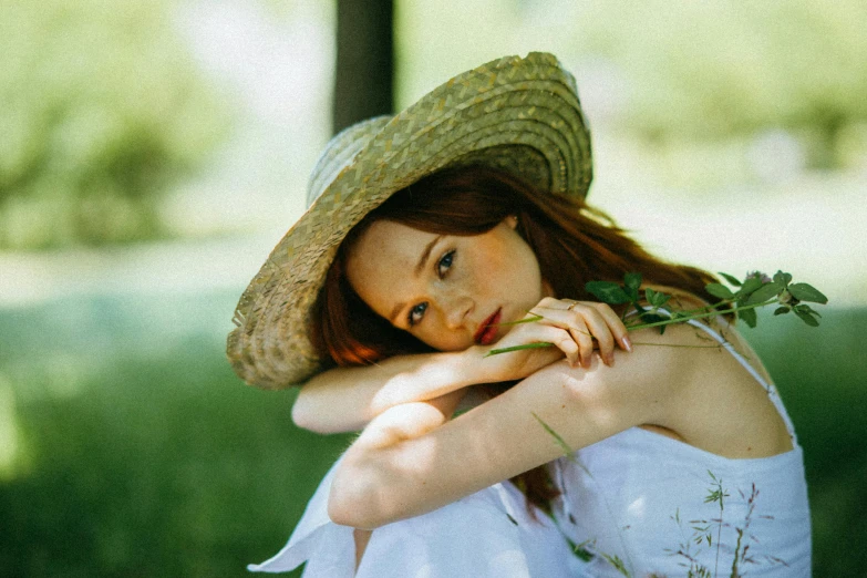 a woman in a straw hat sitting in the grass, pexels contest winner, renaissance, sadie sink, park ji-min, photoshoot for skincare brand, ad image