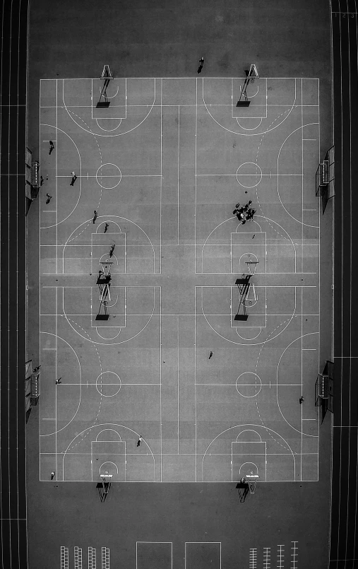 a black and white photo of a basketball court, inspired by Andreas Gursky, unsplash contest winner, birds - eye view, ffffound, people on the ground, outlined