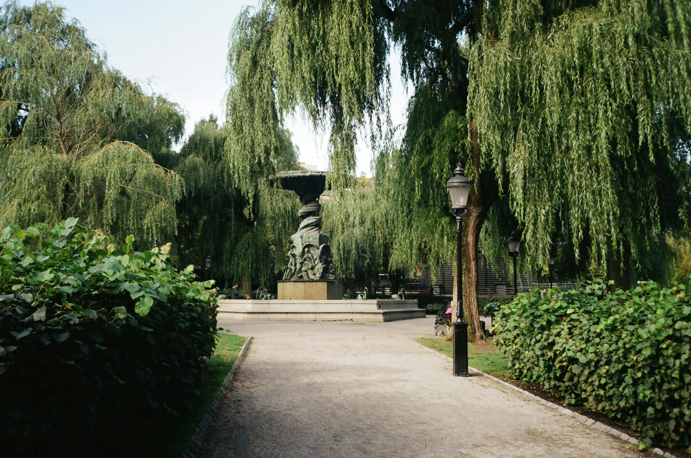 there is a statue in the middle of a park, inspired by Albert Paris Gütersloh, unsplash, weeping willows, post - soviet courtyard, well shaded, kacper niepokolczycki