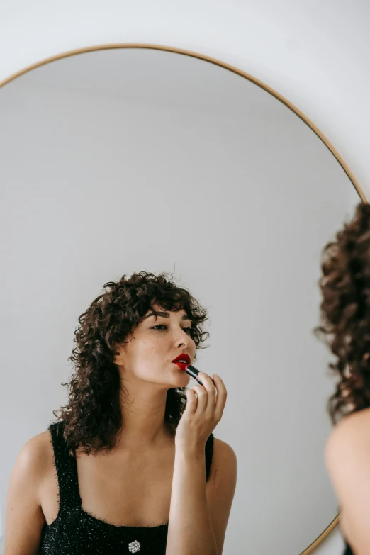 a woman brushing her teeth in front of a mirror, trending on pexels, brown curly hair, sexy lips :5 stylish, wearing professional makeup, woman's profile