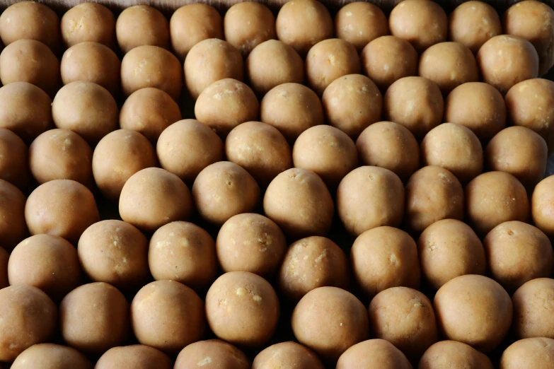 a pile of potatoes sitting on top of a table, metaballs, in rows, light brown, thumbnail