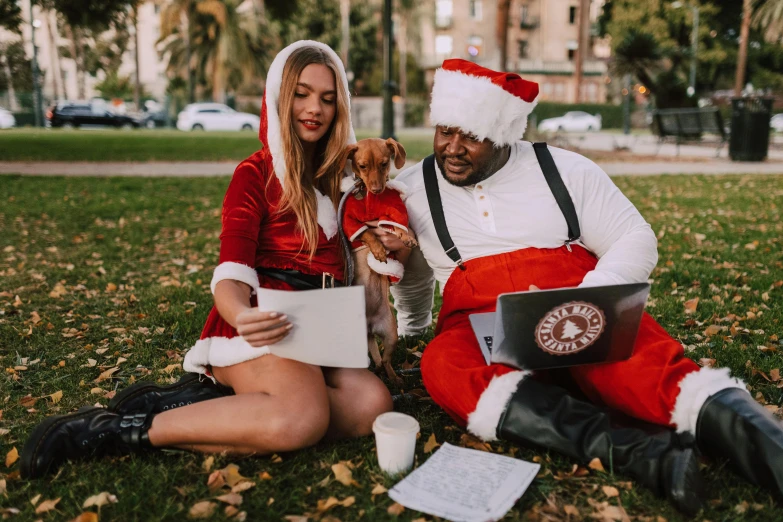a man and woman sitting on the grass with a dog, pexels contest winner, happening, santa clause, avatar image, vanessa morgan, 3 4 5 3 1