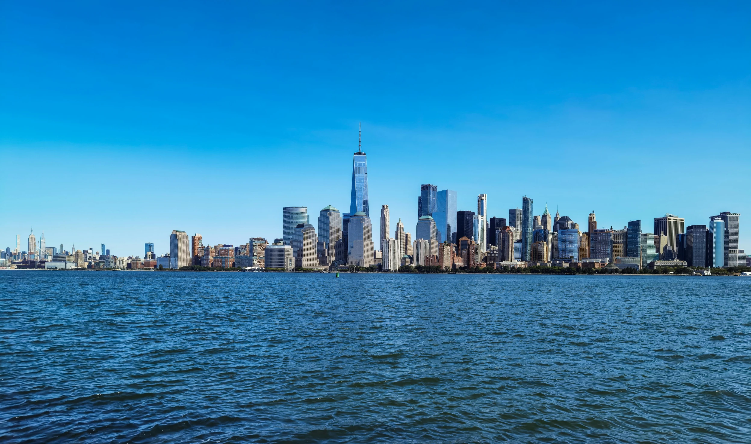 a large body of water with a city in the background, clear blue skies, escape from new york, slide show, 4k image