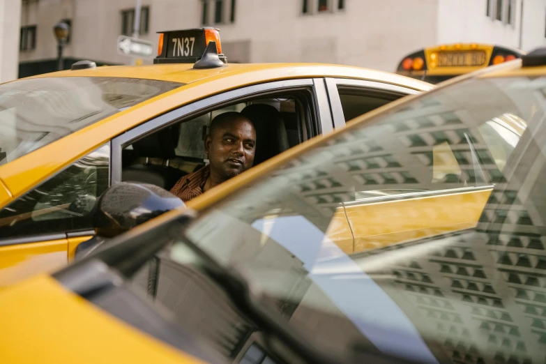 a man sitting in the driver's seat of a taxi, happening, jemal shabazz, multiple stories, in new york, avatar image