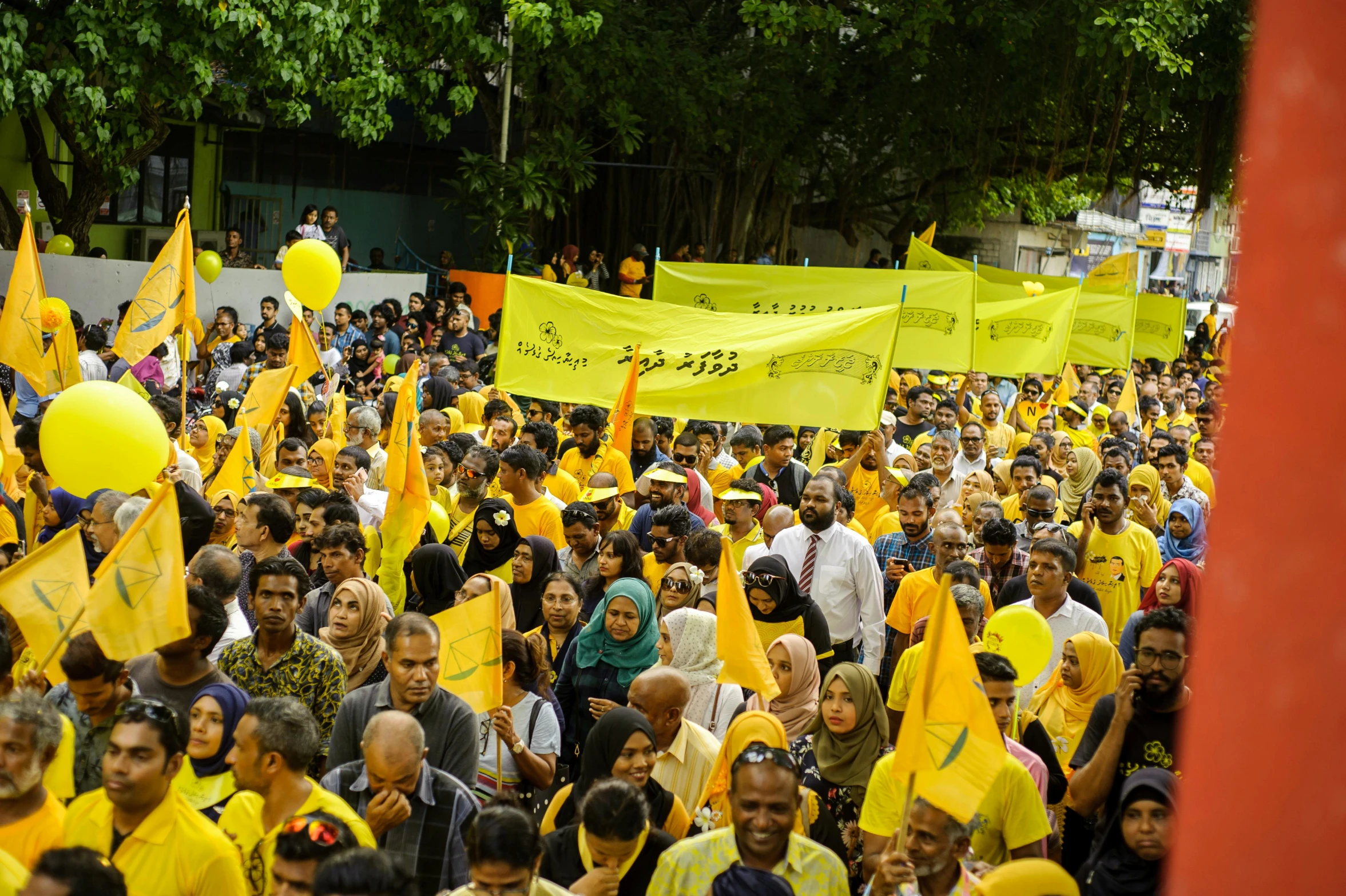 a large group of people holding yellow flags, hurufiyya, kuala lumpur, profile image, thumbnail, high resolution image