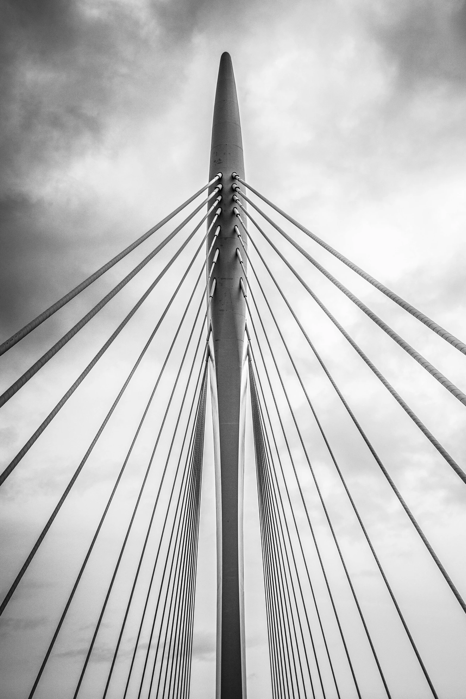 a black and white photo of a bridge, inspired by karlkka, has cables, spire, brushed, medium symmetry