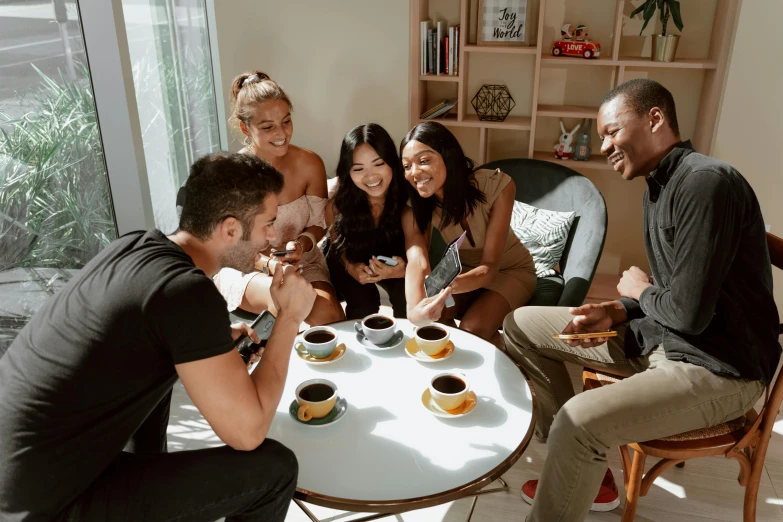 a group of people sitting around a table with cups of coffee, fan favorite, essence, profile image, instagram photo