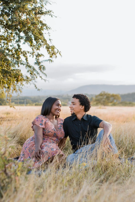 a man and woman sitting next to each other in a field, kezie demessance, on clear background, in a scenic background, nilah