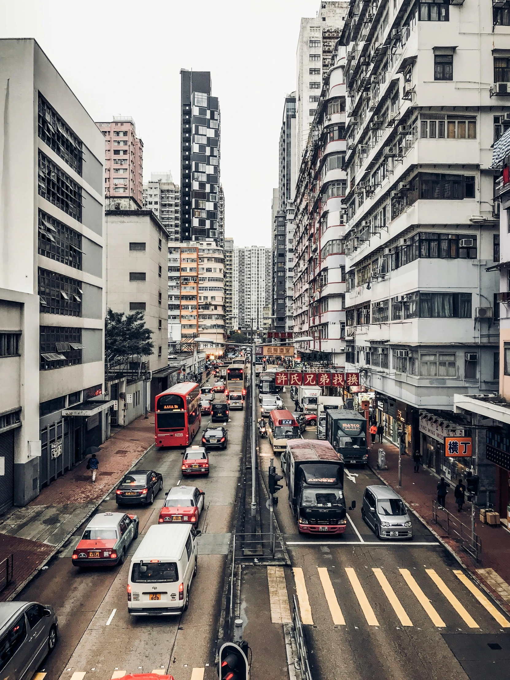 a street filled with lots of traffic next to tall buildings, inspired by Thomas Struth, pexels contest winner, hyperrealism, 🚿🗝📝, chinese heritage, vibrant but dreary, buses