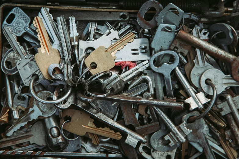 a box filled with lots of keys sitting on top of a table, trending on pexels, assemblage, metal key for the doors, ((rust)), giant crypto vault, steel plating