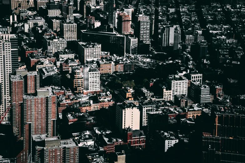 an aerial view of a city with tall buildings, inspired by Elsa Bleda, dark building, high - contrast, poor buildings, charming