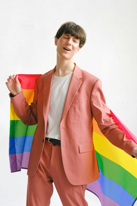 a man in a suit holding a rainbow flag, an album cover, inspired by Louis Hersent, trending on pexels, renaissance, declan mckenna, pink clothes, lesbians, kim doyoung