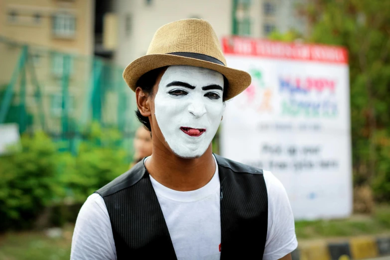 a man wearing a white face paint and a hat, a cartoon, pexels contest winner, mime, transgender, ayan nag, candid photograph