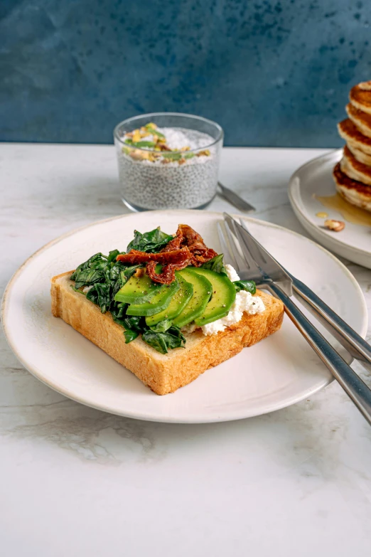 a stack of pancakes sitting on top of a white plate, inspired by Richmond Barthé, renaissance, avocado, toast, detailed product image, eucalyptus