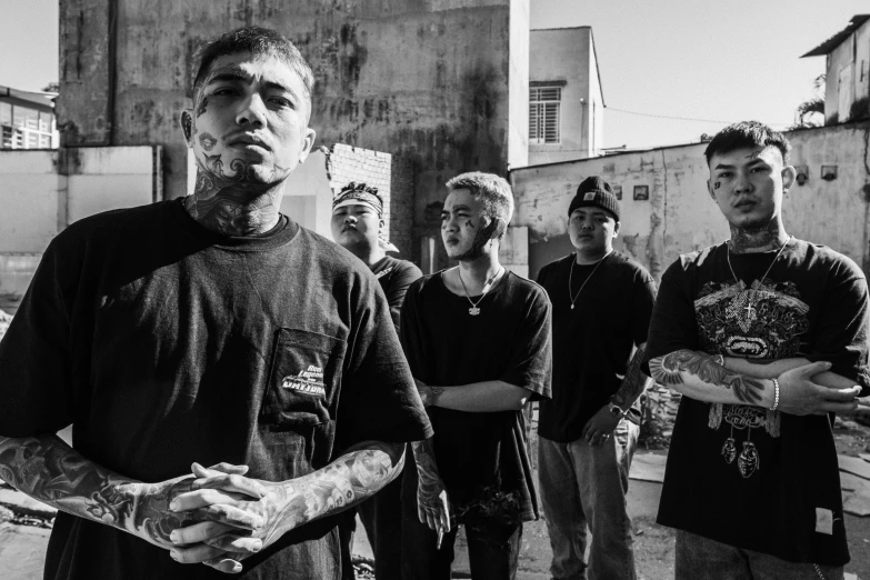 a group of men standing next to each other, a black and white photo, inspired by Xi Gang, pexels contest winner, realism, lil peep, wearing shipibo tattoos, morning golden hour, asian man