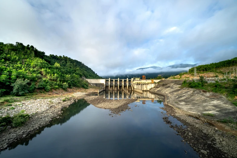 a large body of water next to a forest, by Yasushi Sugiyama, pexels contest winner, hurufiyya, infrastructure, overflowing energy, laos, slide show