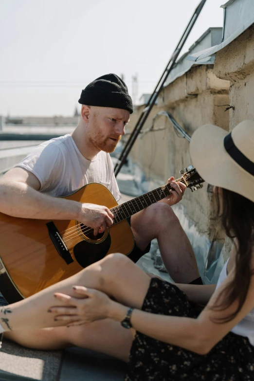 a man sitting next to a woman with a guitar, pexels contest winner, on a rooftop, hr ginger, on a boat, soft shade