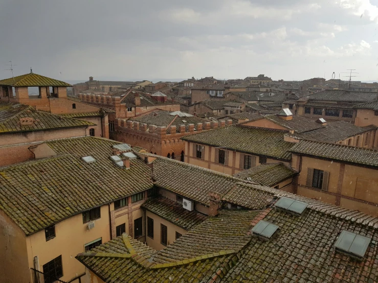 a view of a city from the top of a building, an album cover, inspired by Romano Vio, pexels contest winner, renaissance, tiled roofs, overcast, sienna, square