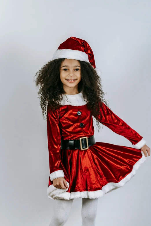a little girl dressed in a santa costume, avant designer uniform, diverse costumes, in style of addy campbell, with a sleek spoiler