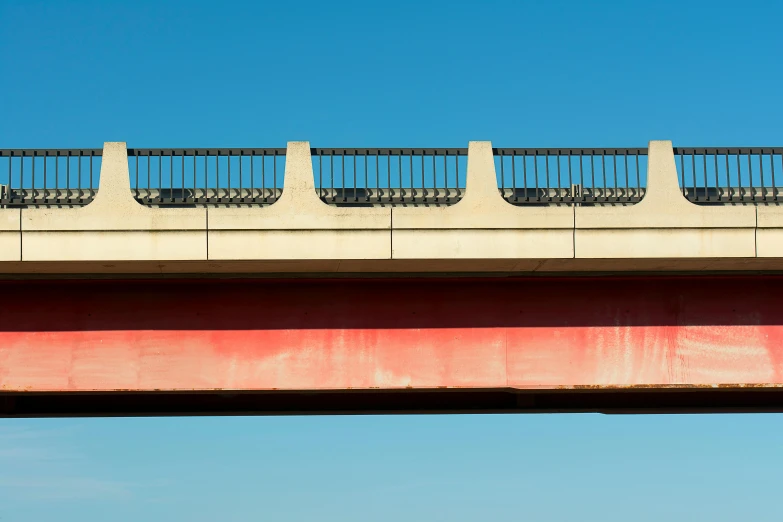 a man riding a skateboard on top of a bridge, inspired by Robert Bechtle, postminimalism, archival pigment print, red and blue, detail structure, minimalist photo