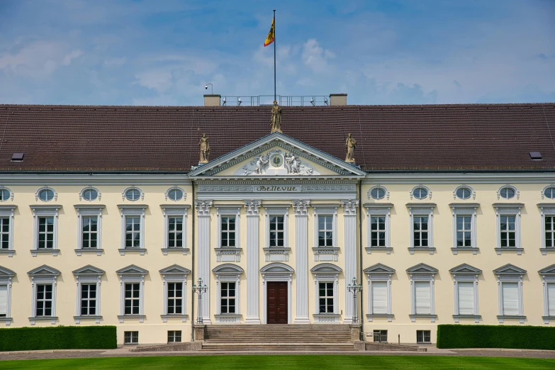 a large building with a flag on top of it, a portrait, pexels contest winner, heidelberg school, thumbnail, detmold charles maurice, palace of the chalice, front facing