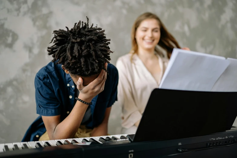 a man sitting in front of a keyboard next to a woman, an album cover, pexels contest winner, frustrated expression, black teenage boy, sheet music, 15081959 21121991 01012000 4k