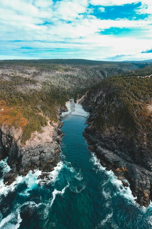 a river flowing through a lush green valley, pexels contest winner, les nabis, cliffside ocean scene, quebec, aerial view, rock arches