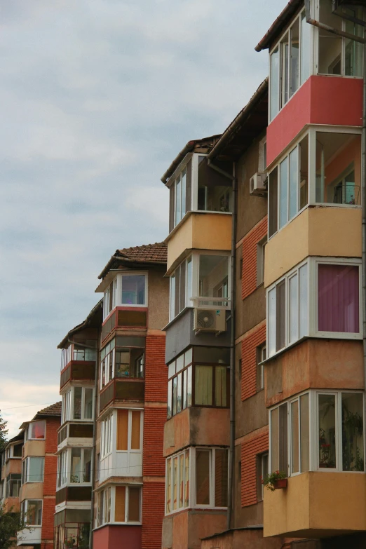 a group of tall buildings sitting next to each other, a photo, by Attila Meszlenyi, terraced, colors, 15081959 21121991 01012000 4k