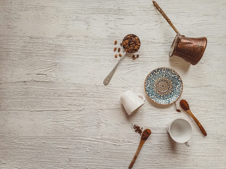 a couple of spoons sitting on top of a wooden table, a still life, trending on pexels, moroccan tea set, background image, white backdrop, gif