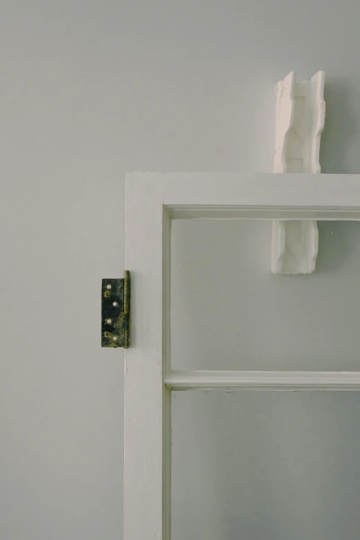 a white toilet sitting in a bathroom next to a window, inspired by Rachel Whiteread, unsplash, conceptual art, flat metal hinges, close up shot from the side, white with black spots, ivory rococo