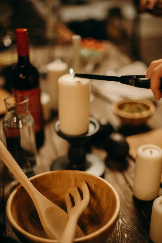 a wooden bowl sitting on top of a wooden table, holding a torch, scene from a dinner party, blending, holding a candle