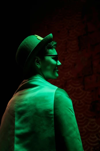 a man in a green suit and top hat, a hologram, by Jason Felix, unsplash, burlesque psychobilly, profile image, red son, non-binary