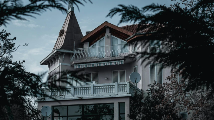 a large white house with a steeple on the roof, by Matija Jama, pexels contest winner, art nouveau, balconies, dark deco, inter dimensional villa, photo for a store