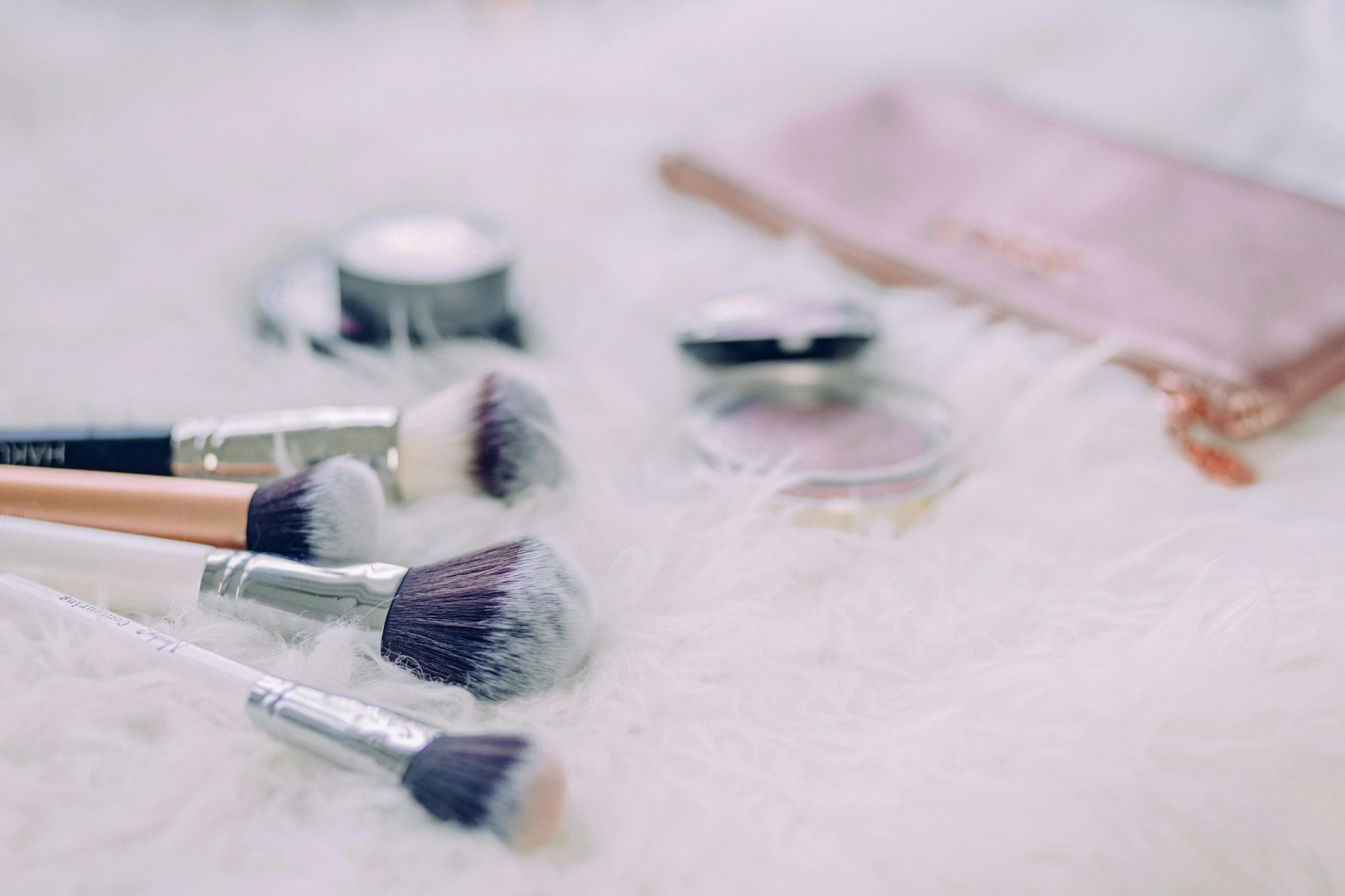 a close up of a bunch of makeup brushes, by Julia Pishtar, pexels contest winner, plasticien, silver，ivory, looking cute, video footage, powder