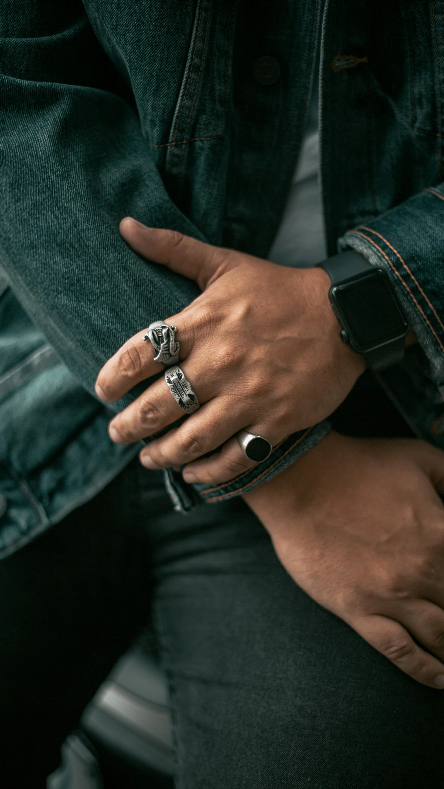 a close up of a person wearing a ring, a black and white photo, inspired by L. A. Ring, trending on pexels, biker, jakarta, dressed in a worn, four hands