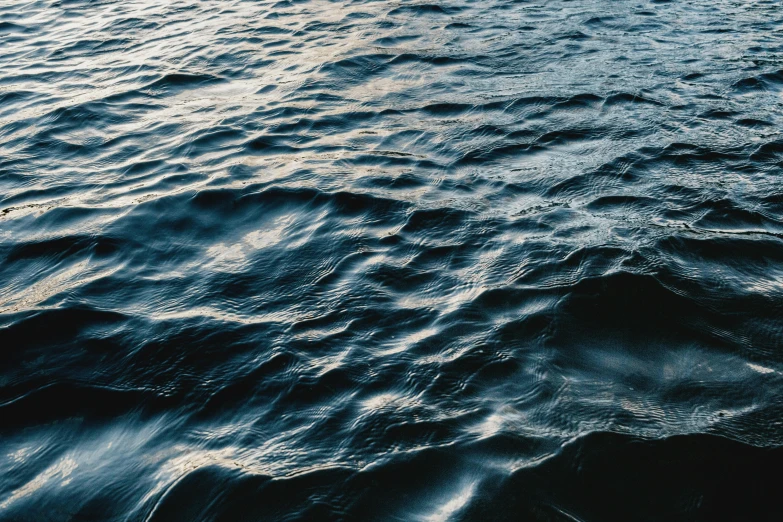 a close up of a body of water with waves, unsplash, navy, instagram post, dimly - lit, lakeside