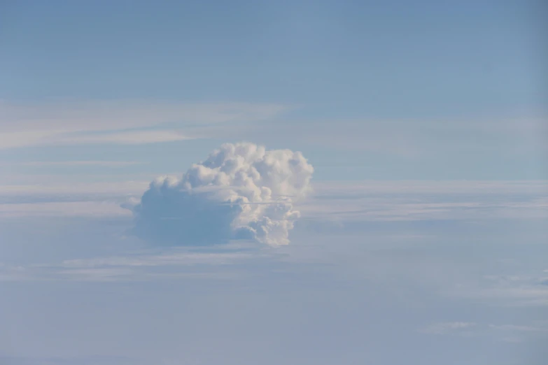 a cloud in the sky as seen from an airplane, by Jan Rustem, unsplash, surrealism, mushroom cloud, uniform off - white sky, taken in the early 2020s, sitting in a fluffy cloud