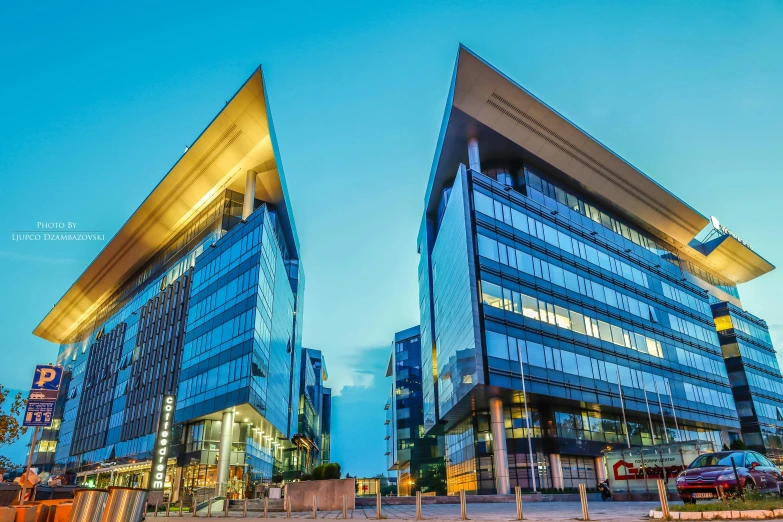 a couple of buildings that are next to each other, full of clear glass facades, uhq, square, vibrant setting