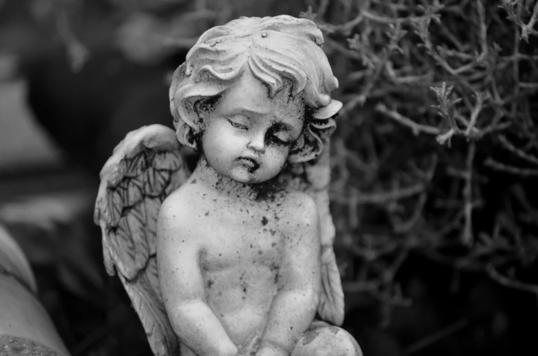 a black and white photo of a statue of an angel, a statue, pexels, with a hurt expression, cherub, ancient fairy dust, portrait of a small