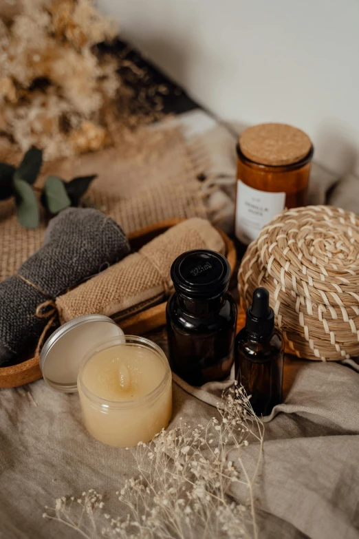 a bunch of items sitting on top of a table, trending on pexels, folk medicine, diffused natural skin glow, brown, product display photograph