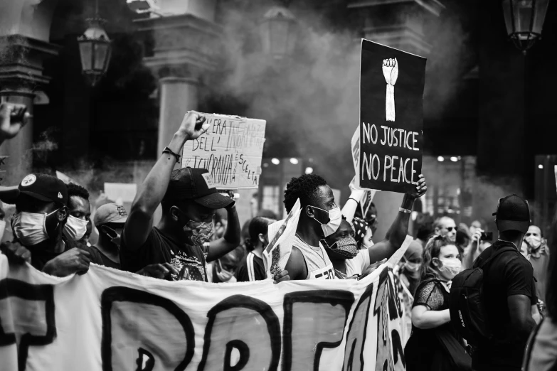 a black and white photo of a group of people holding signs, by Eric Peterson, pexels, the world is on fire, taken on iphone 14 pro, justice, photo of a black woman