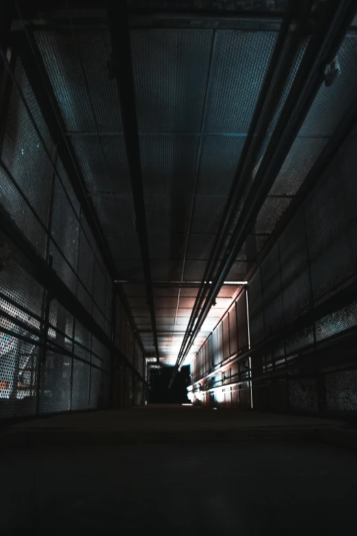 a man riding a skateboard down a dark hallway, inspired by Elsa Bleda, unsplash, dark abandoned cyberpunk factory, volumetric light from below, location [ chicago ( alley ) ], cinematic view from lower angle