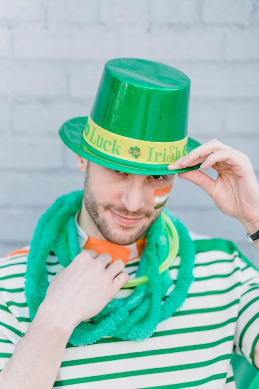 a man wearing a green hat and scarf, inspired by Mór Than, pots of gold, 🚿🗝📝, party hats, stripes