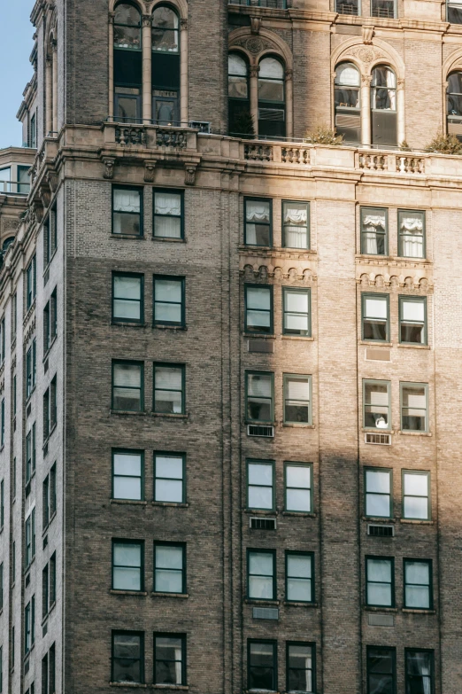 a tall building with a clock on top of it, rundown new york apartment, soft sunlight dappling, 2019 trending photo, unsplash contest winning photo