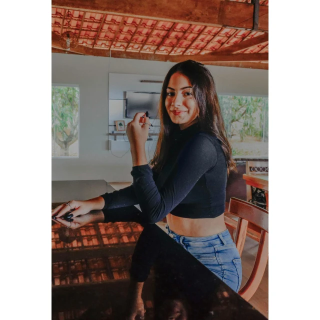 a woman sitting on top of a wooden table, by Robbie Trevino, happening, on kitchen table, tanned ameera al taweel, avatar image, black top